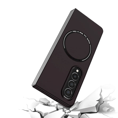Black phone case with triple camera cutout and magnetic ring, shown over cracked white surface