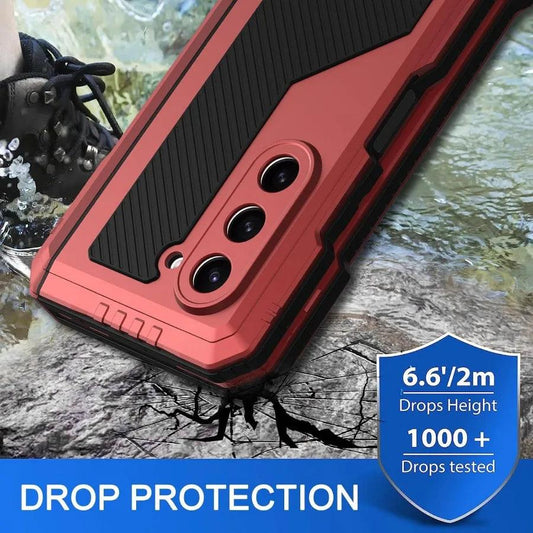 Red and black rugged phone case with triple camera cutout shown on cracked surface advertising drop protection