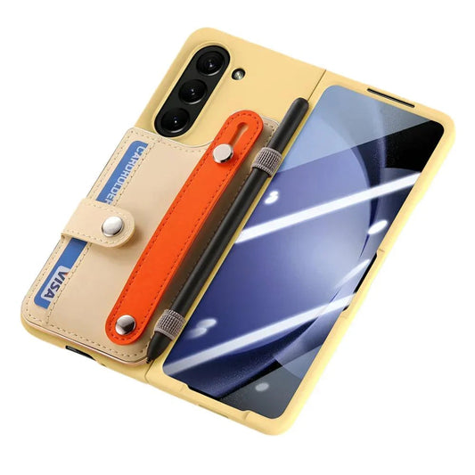 Yellow foldable smartphone with triple rear cameras and attached beige cardholder and orange strap
