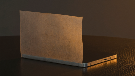 A book-style foldable smartphone partially concealed under warm-lit vellum paper on a dark walnut desk — investigative pre-launch editorial hero for the Galaxy Z Fold 8 rumor tracker