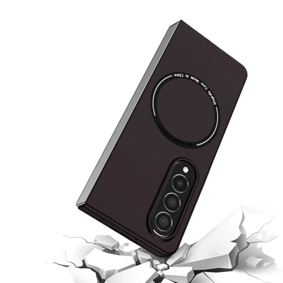 Black phone case with triple camera cutout and magnetic ring, shown over cracked white surface