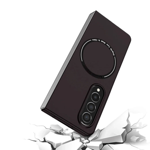 Black phone case with triple camera cutout and magnetic ring, shown over cracked white surface