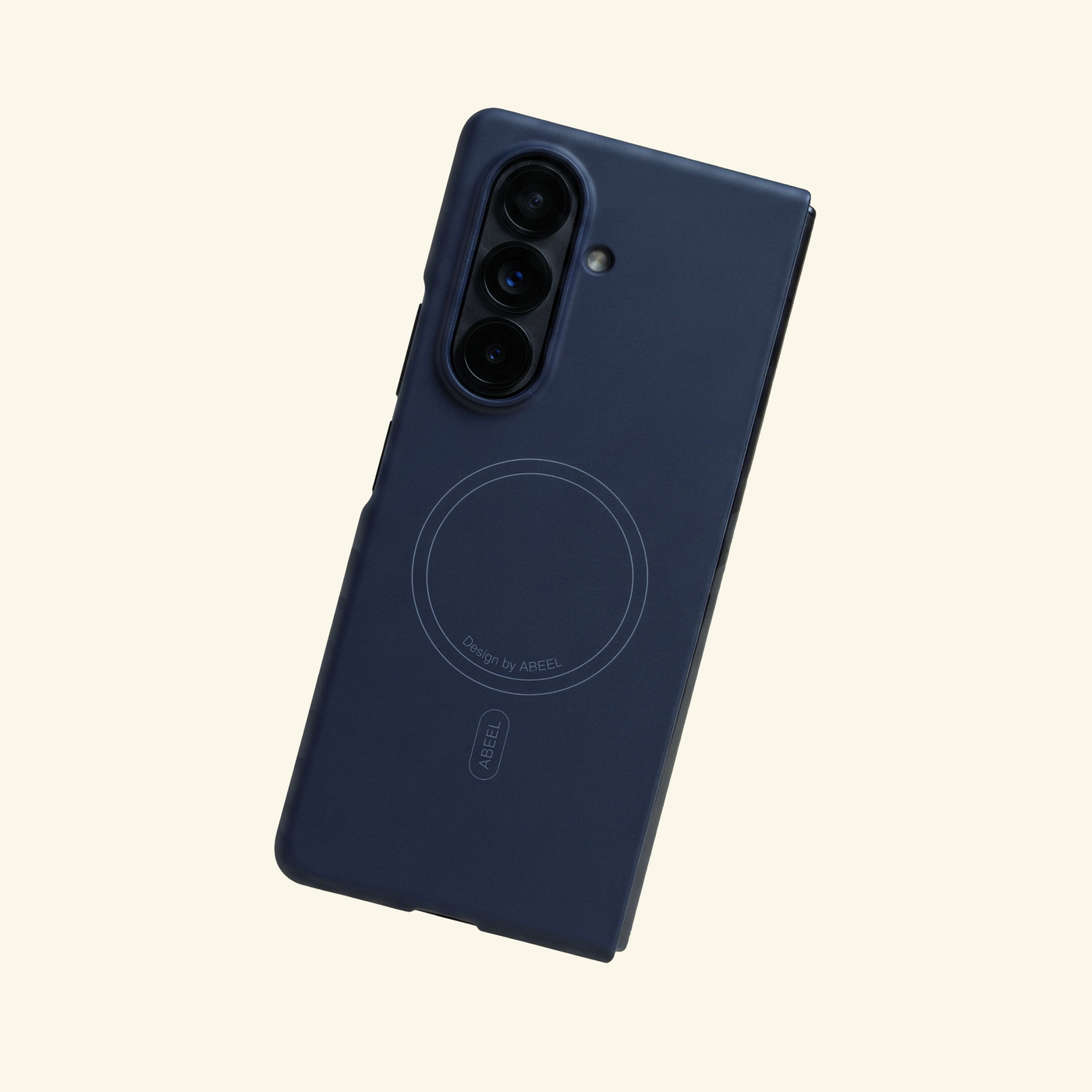 Apex M3 navy blue folding phone case with magnetic alignment ring, on cream background