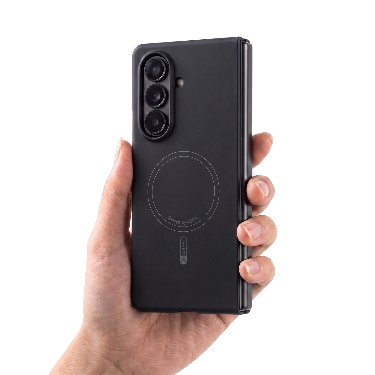 Hand holding a Galaxy Z Fold in the Black Apex M3 case, showing its slim in-hand feel